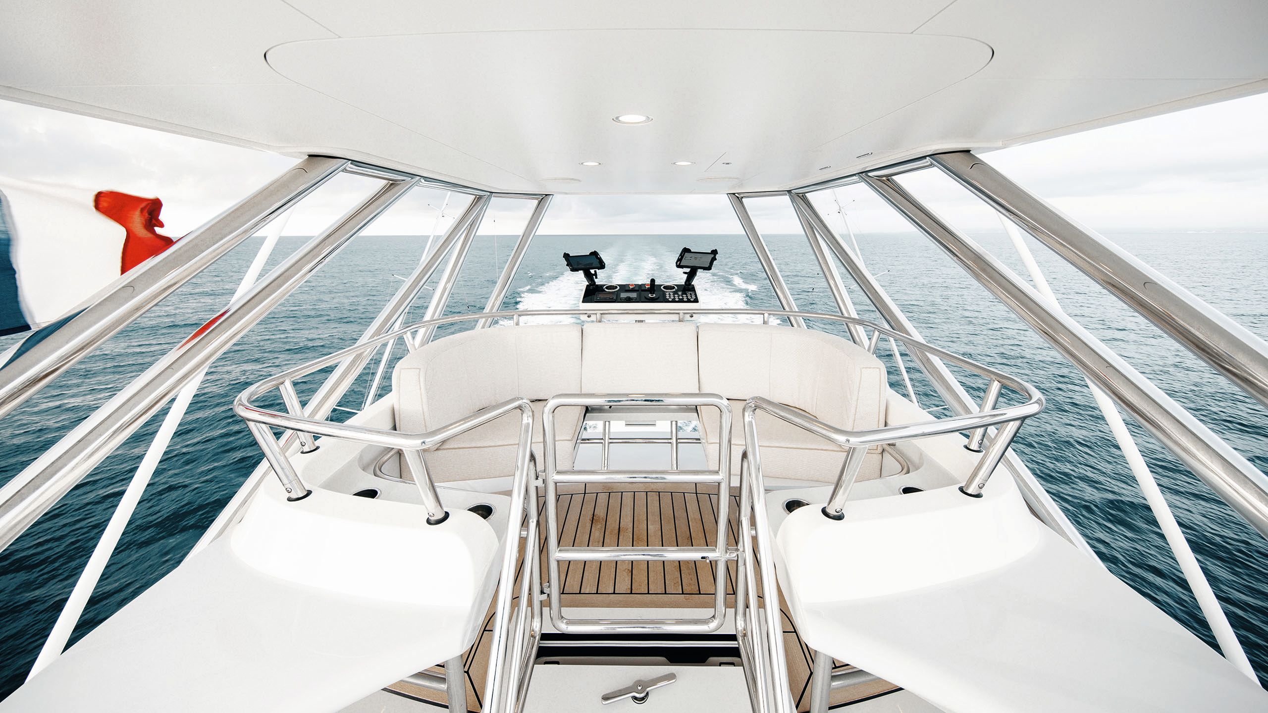 Curved white sofa at the top of the tuna tower, surrounded by chrome rails