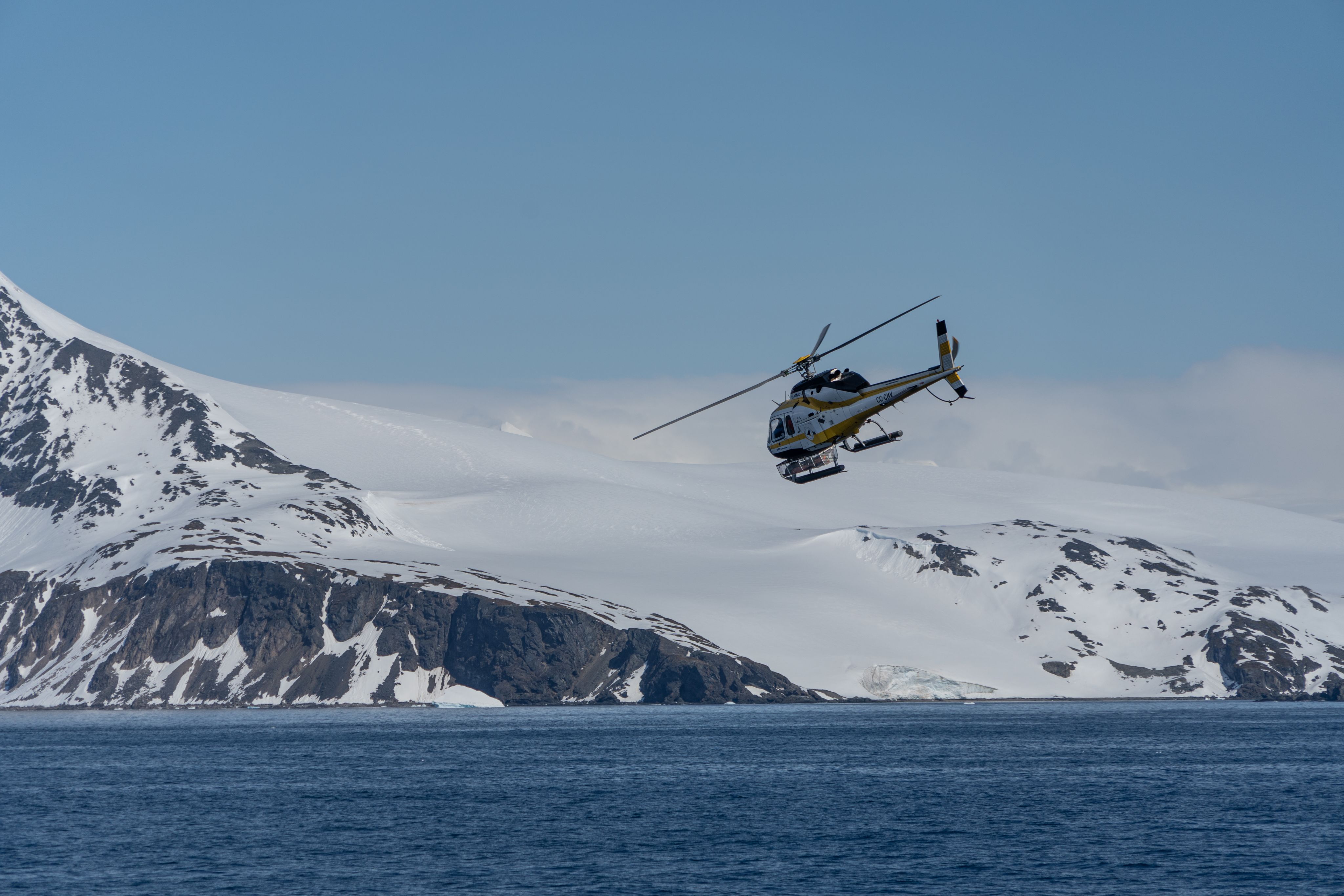 Helicopter over snowy mountain 